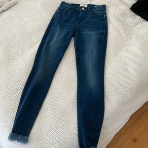 Frame denim jeans with distressed bottoms
